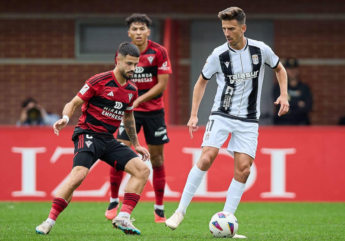 Dos jugadores del Mirandés bloquean al albinegro Juan Carlos Real.