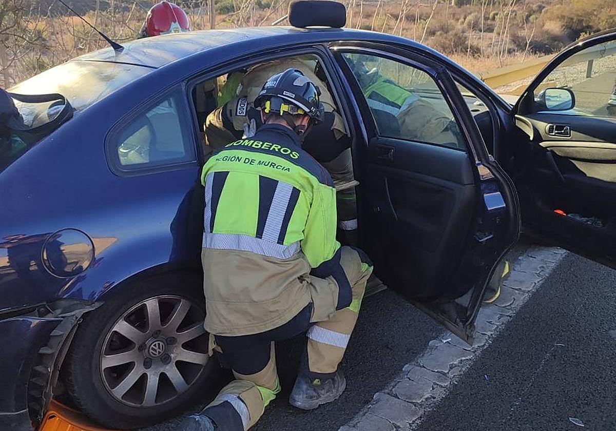 Bomberos trabajando en uno de los vehículos accidentados.