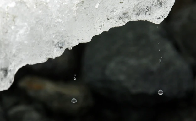 Droplets break off a chunk of ice on the Arolla Glacier in the Swiss Alps near Sion.