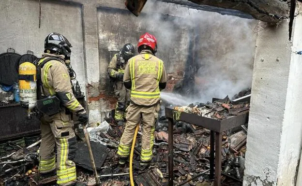 Firefighters work to put out the fire.