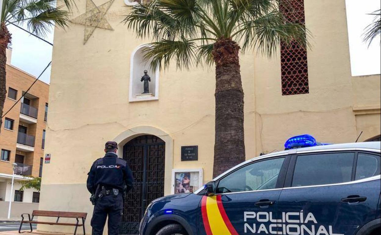 Un agente de la Policía Nacional frente a una iglesia.