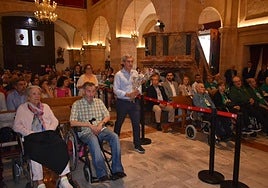 Representantes de la ONCE portan las ofrendas hacia el altar durante la ceremonia en el interior de la basílica.