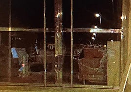 Butrón en un cristal de uno de los establecimientos asaltados, en San Javier.