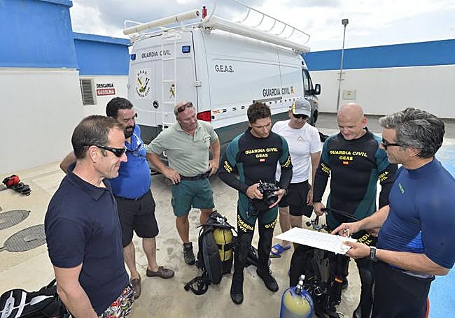 Carlos de Juan (d), con otros técnicos y un equipo de la Guardia Civil, prepara una inmersión al yacimiento de La Isla, en 2019.