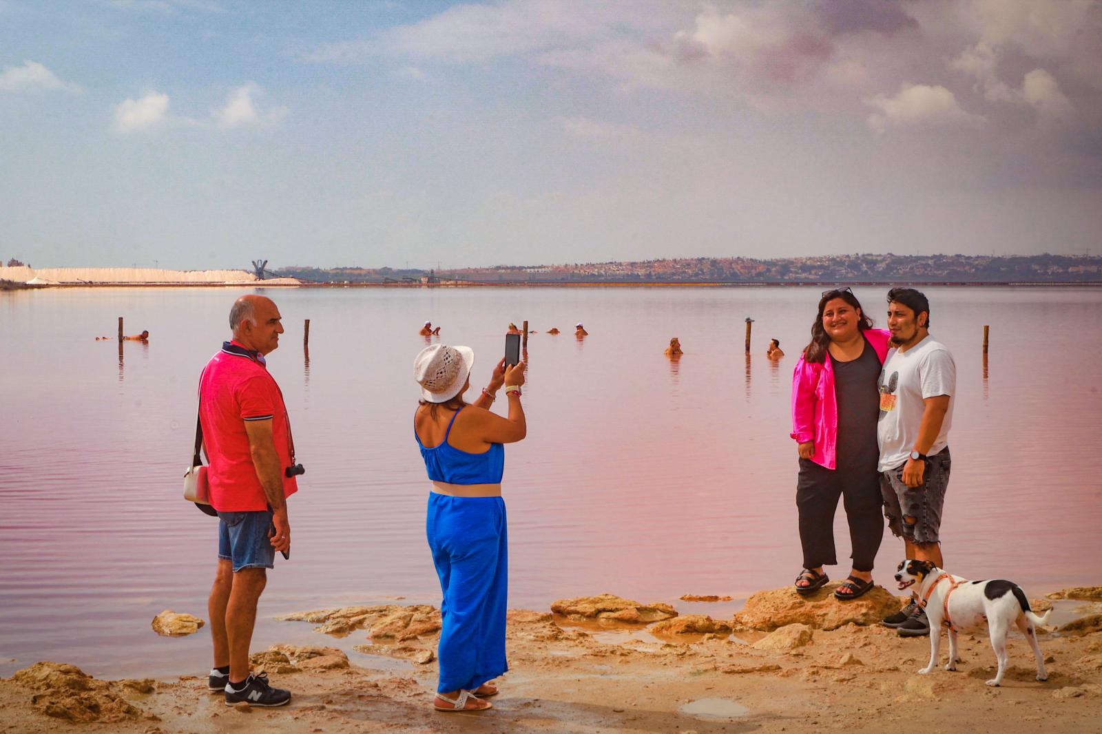 Los turistas toman las orillas de la Laguna Rosa de Torrevieja pese a la prohibición al baño