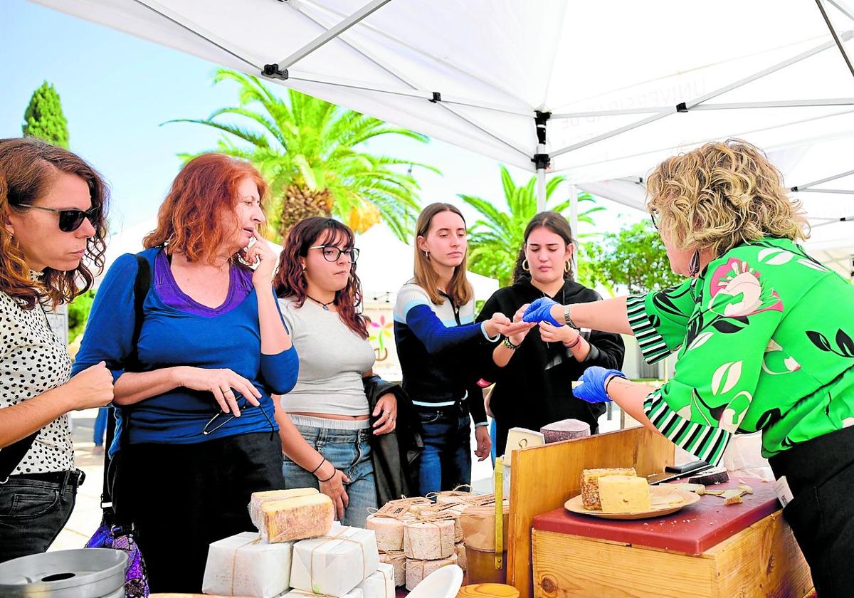 Varios alumnos prueban alimentos sostenibles en la feria.