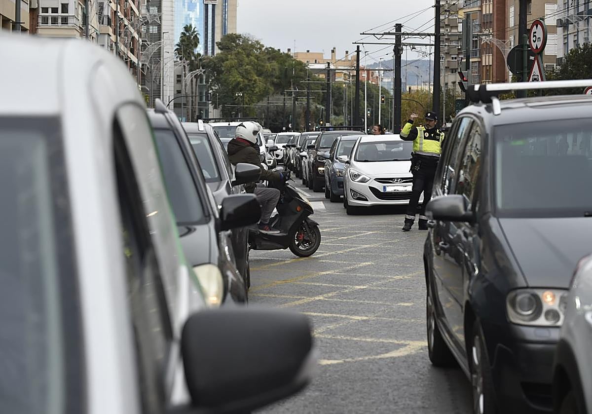 Imagen principal - Retenciones en la vía, un investigador realiza fotos del lugar del impacto y daños en el autobús tras la caída del hombre.