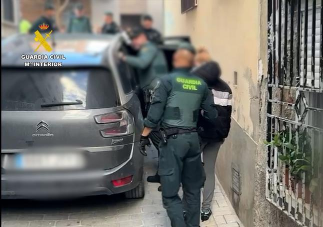 Los agentes con uno de los detenidos.