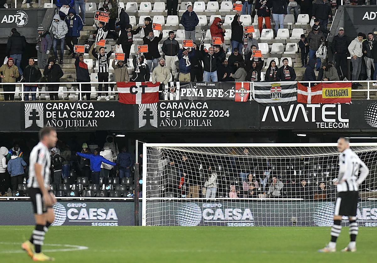 Aficionados del Efesé con carteles de 'Se vende' en la grada del Cartagonova en el encuentro ante el Albacete de esta temporada.