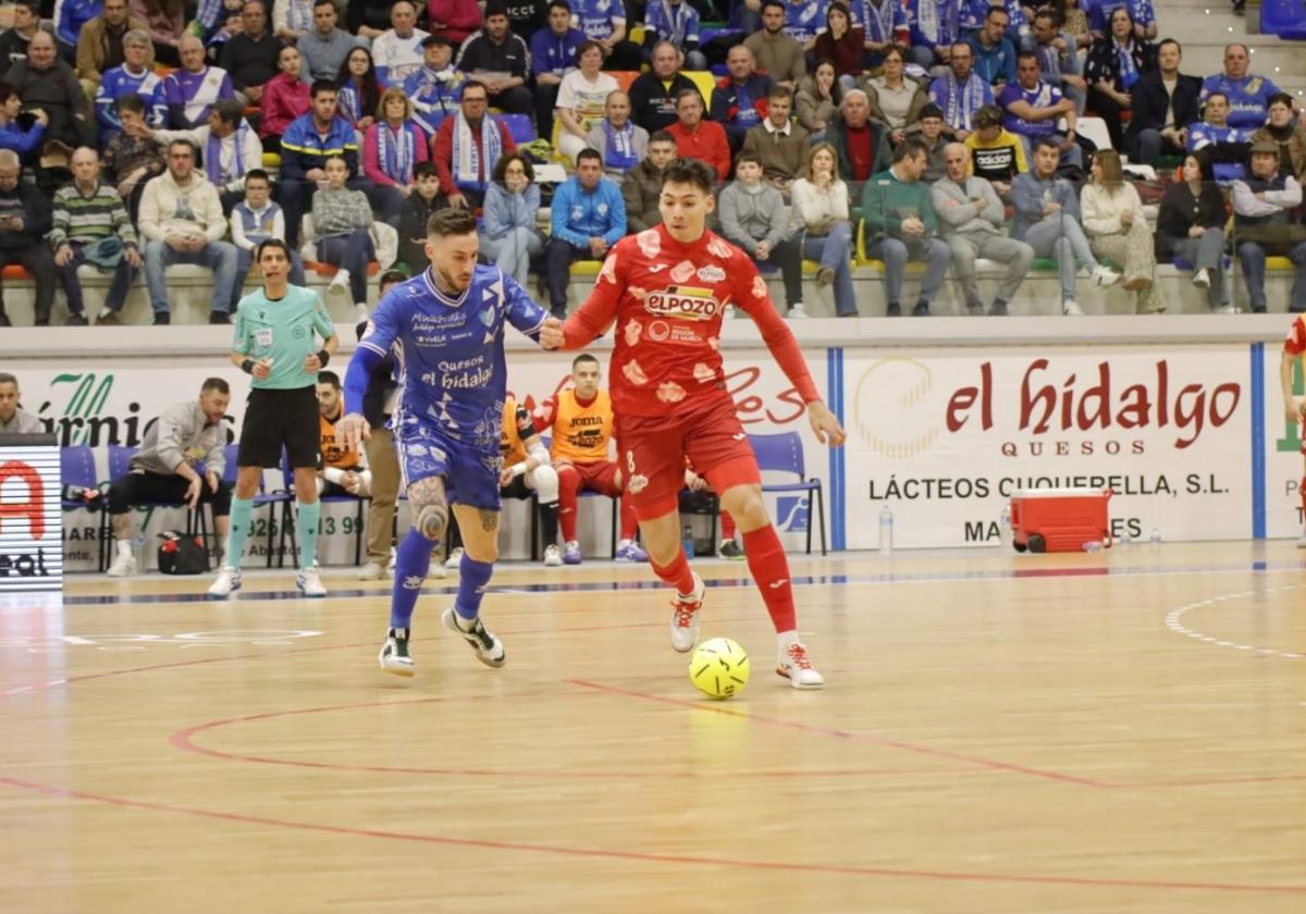 Ricardo Mayor conduce el balón en presencia de Antoñito en el duelo jugado ayer en Manzanares.