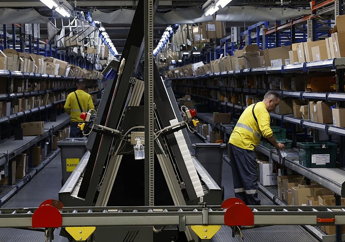 Dos operarios preparan productos farmacéuticos en el almacén de Hefame, en Santomera.