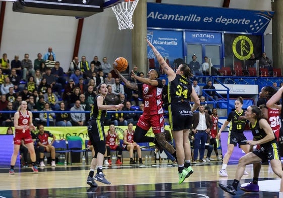 Massey trata de impedir la canasta de Atkinson en el partido de liga en Alcantarilla.