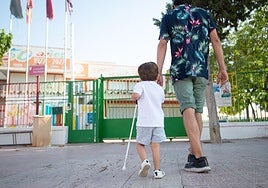 Un niño invidente es acompañado por su padre al colegio en una imagen de archivo.