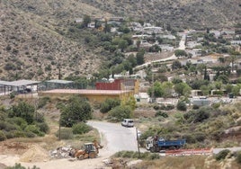 Movimiento de camiones, máquinas y escombro, este viernes, junto al acceso al camping.