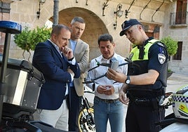 Un agente muestra el dron a las autoridades, ayer.