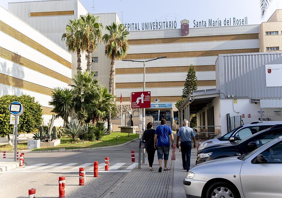 Tres personas caminan en dirección a una de las entradas al hospital de Santa María del Rosell, en una imagen de archivo.
