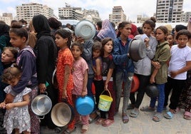 Cola de palestinos, la mayoría niños, para conseguir algo de comida en Gaza.