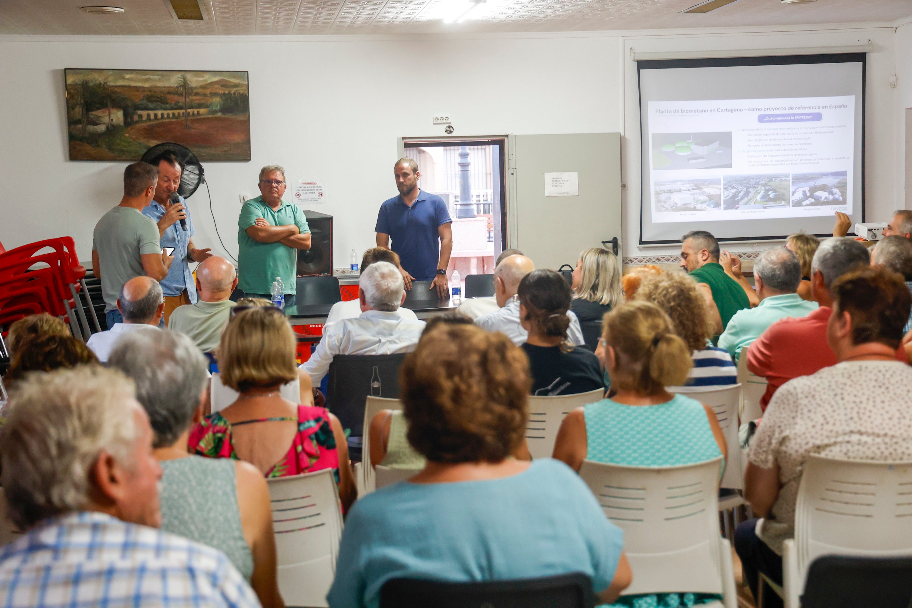 Los técnicos de la empresa escuchan al presidente vecinal, durante la reunión informativa.