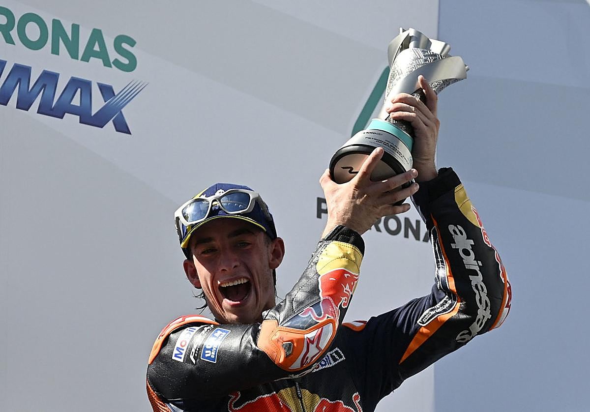 Acosta, segundo en el podio, muestra su trofeo.