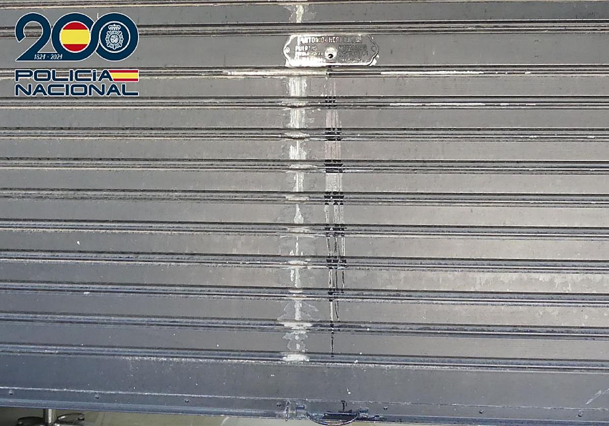 Estado de la persiana de uno de los comercios afectados, tras echarle pegamento industrial a la cerradura.