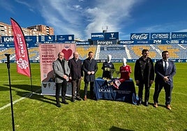 Representantes de ambos equipos y Cáritas, este miércoles, en el césped de La Condomina.