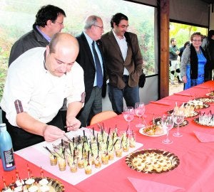 Domingo Valero prepara los vasitos de hongos escabechados. Detrás, Domingo Aranda (c) y Fernando Galán (d). ::
M. A. R.