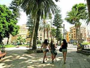 Tres chicas pasean, bajo la sombra de los árboles, por la céntrica Plaza de La Merced. ::
J. M. RODRÍGUEZ