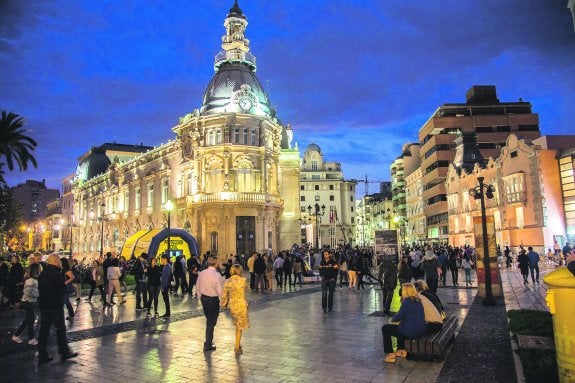 Un gentío, al anochecer en la Plaza del Ayuntamiento, transitó entre el puerto y el casco histórico. A la izquierda, el modernista Palacio Consistorial; a la derecha, el Museo del Teatro                    Romano. 