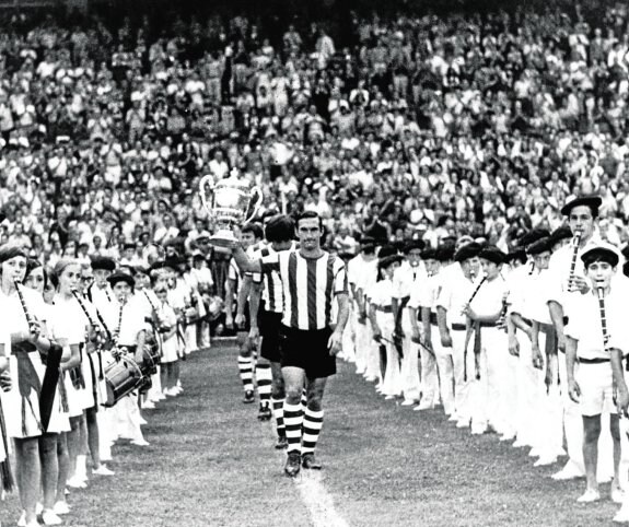 Aranguren, con la Copa de España en la mano, salta al césped de San Mamés, seguido por sus compañeros, en el homenaje a los campeones de 1973.
