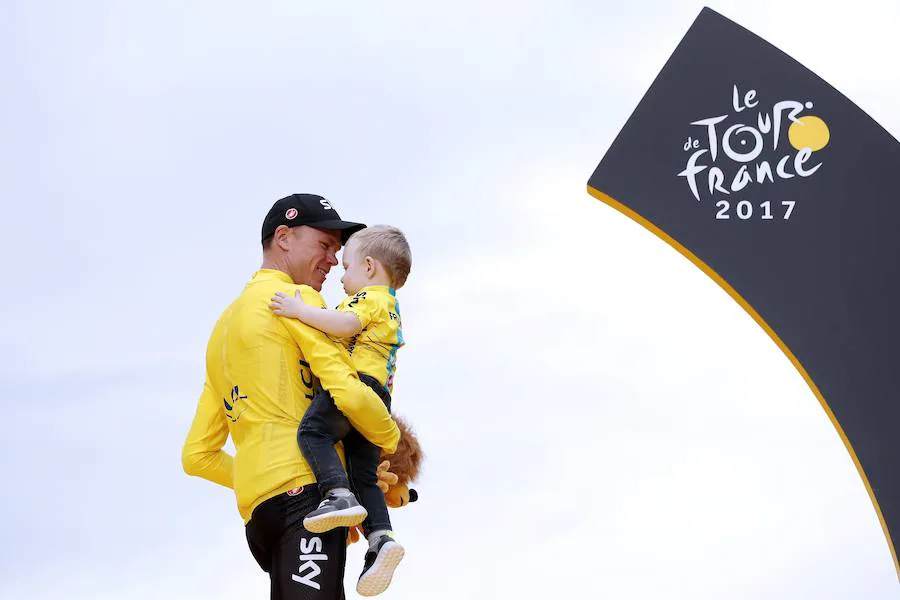 Chris Froome sujeta en brazos a su hijo en el podio de los Campos Elíseos. 