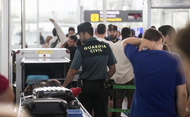 Agentes de la Guardia Civil custodian los accesos a las puertas de embarque.