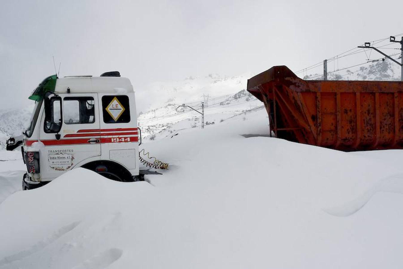 La vía férrea que une León y Asturias, afectada por la nieve. En la imagen, un tren parado en la estación de Busdongo (León) || La nieve frena al tren en el Puerto de Pajares. Las intensas nevdas están frenando en seco el tráfico ferroviario