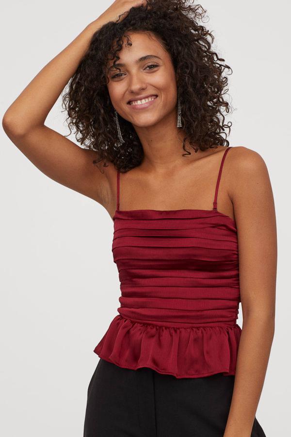 Top drapeado en color rojo oscuro de H&M (29,99 euros).