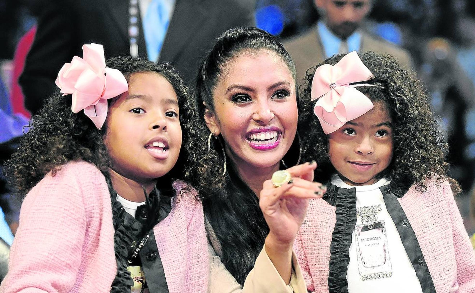 Vanessa Bryant saluda en el Staples Center, el pabellón de los Lakers, en un partido junto a sus dos hijas pequeñas.