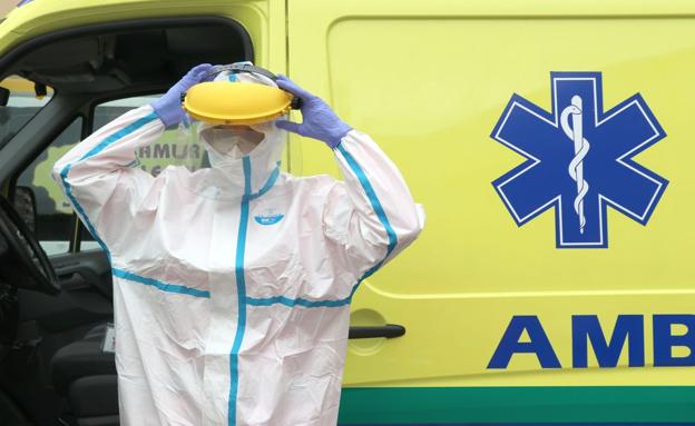 Un técnico de ambulancia se coloca el EPI con el que debe acudir ahora a urgencias de la covid.