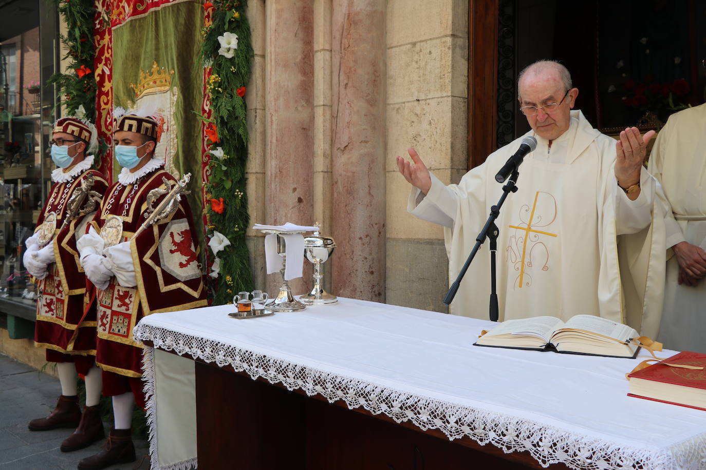 Unas mujeres reciben la comunión mientras portan mascarillas.
