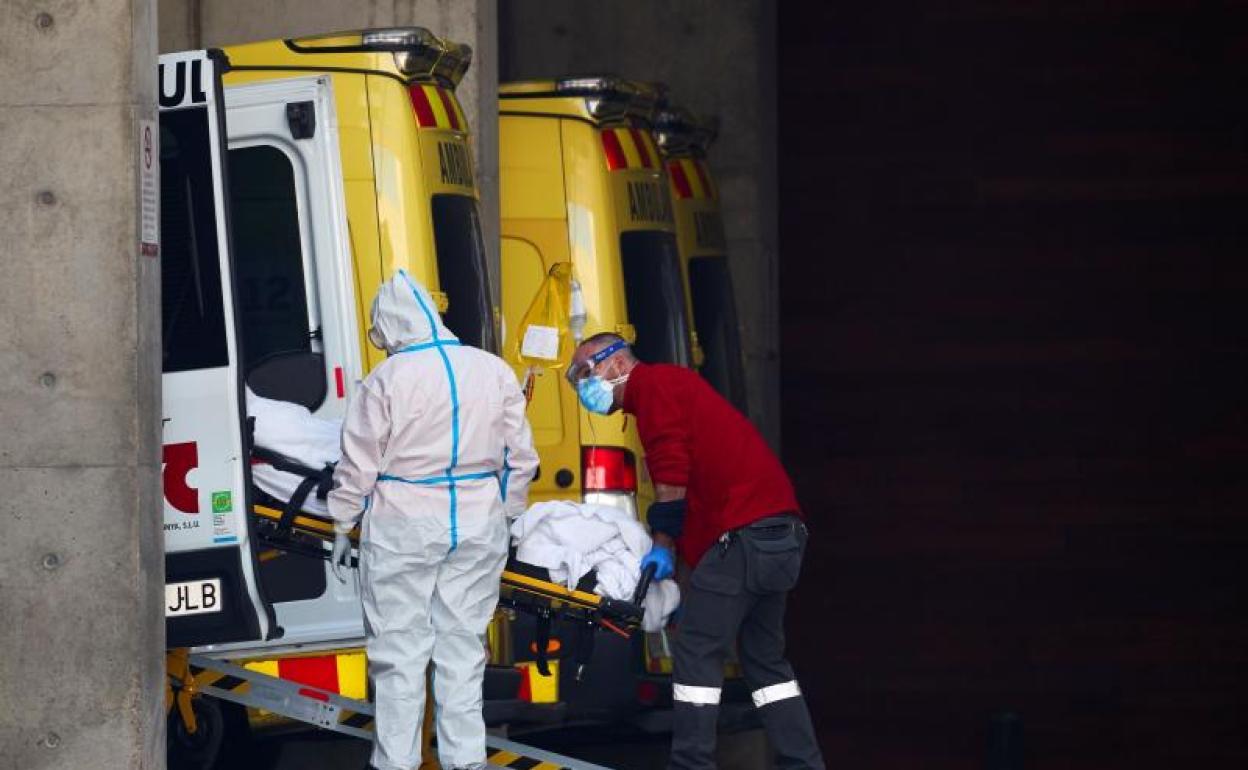 Dos profesionales sanitarios trasladan a un paciente en el hospital de Bellvitge, en Barcelona 