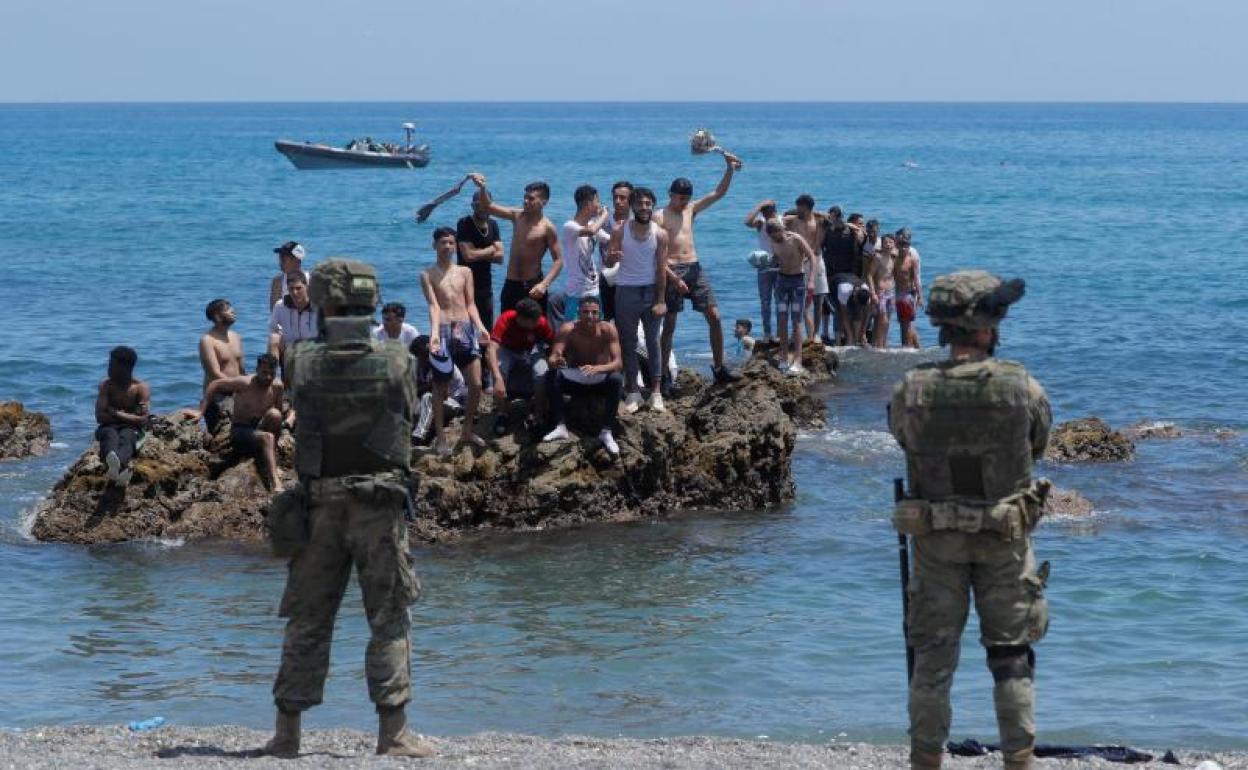 Dos militares vigilan la playa de El Tarajal. 