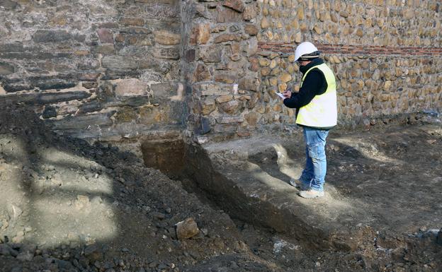 Arranque del cubo semicircular, un arqueólogo documenta el arranque del cubo y vista la excavación desde lo alto de la muralla tardorromana. 