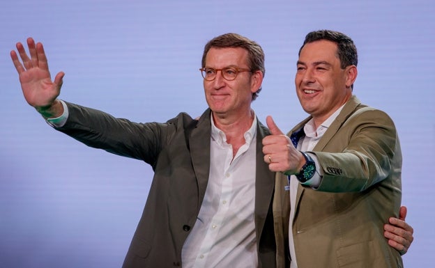 El líder del PP, Alberto Núñez Feijóo (i), y el presidente de la Junta y candidato a la reelección, Juanma Moreno, saludan este domingo en Sevilla durante un acto de la precampaña de las andaluzas.