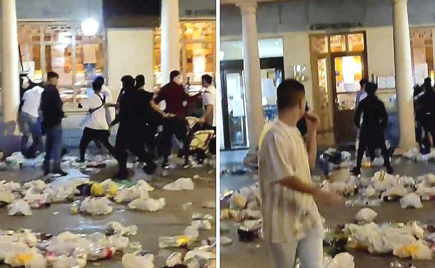 Captura de pantalla de un vídeo en el que se aprecia a un joven lanzando mobiliario comercial sobre otros participantes en la multitudinaria pelea de la Noche Larga en Astorga.