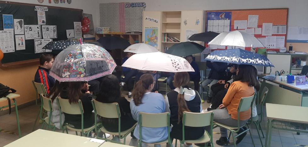 Alumnos del Colegio San Claudio acuden a clase con paraguas debido a las goteras.