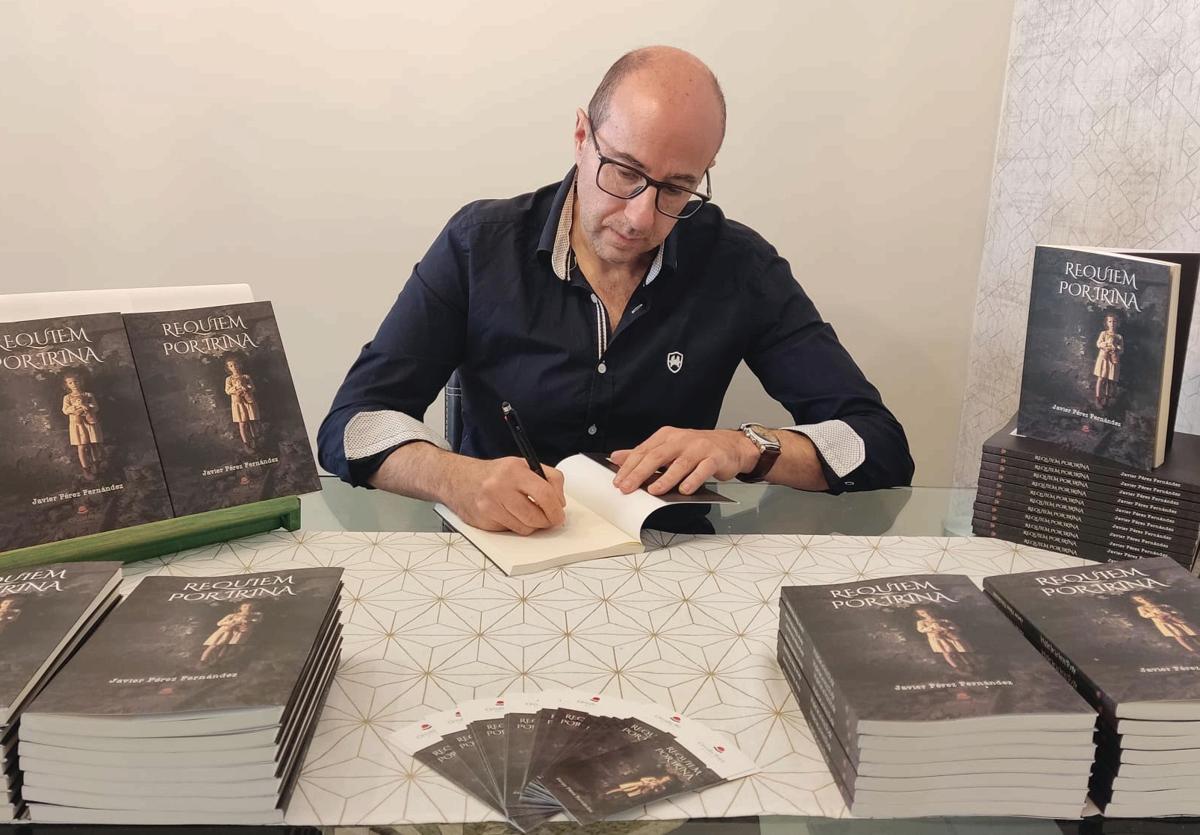 El leonés Javier Pérez Fernández firma ejemplares de su primera novela, 'Requiem por Irina'.