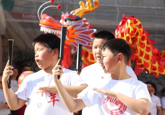 Un grupo de leoneses bailan el dragón chino en la plaza de Botines.