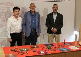 Emilio Fernández, Vicente Canuria y Emilio Martínez posan junto a elementos típicos de juegos tradicionales leoneses.