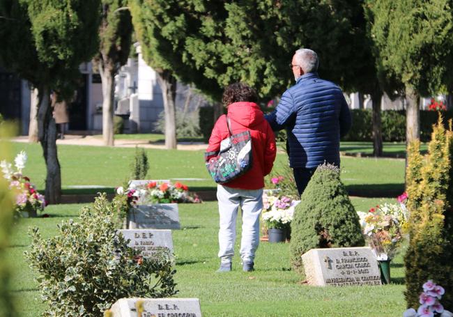 Dos personas paseando entre las lápidas