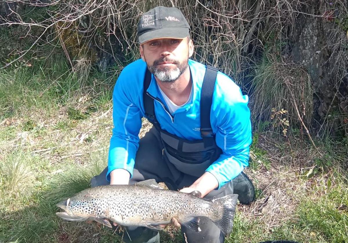 Un pescador leonés con una de sus capturas.