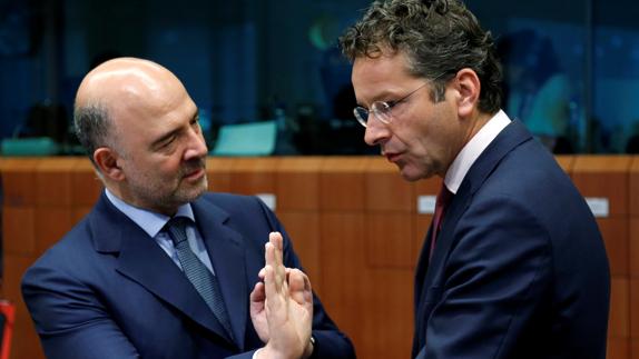 Pierre Moscovici habla con Jeroen Dijsselbloem. 