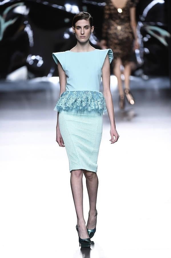 Vestido azul con hombreras y volante de encaje en la cintura.