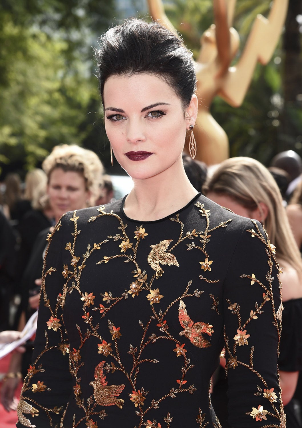 La protagonista de la serie 'Blindspot', Jaimie Alexander lució un recogido con tupé y maquillaje 'vamp', con la piel muy blanca y labios burdeos.
